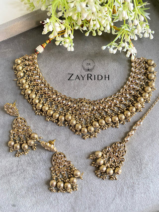 golden necklace set with tikka and earrings