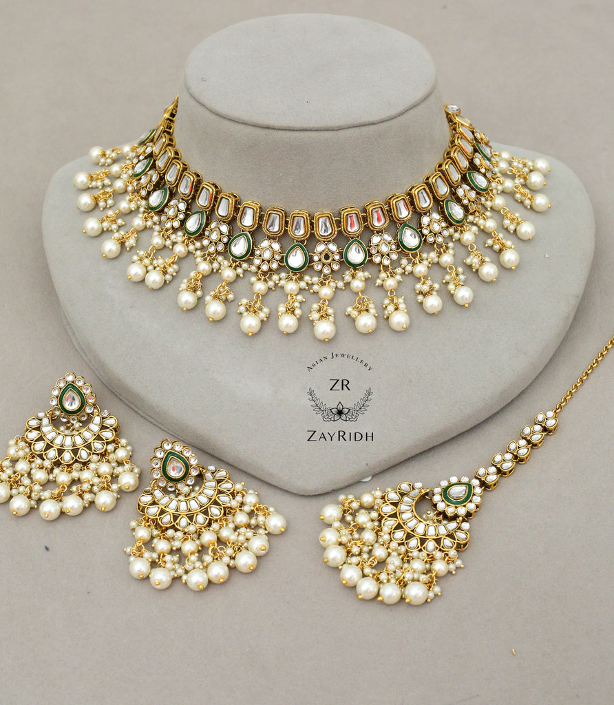 white choker necklace with tikka and earrings