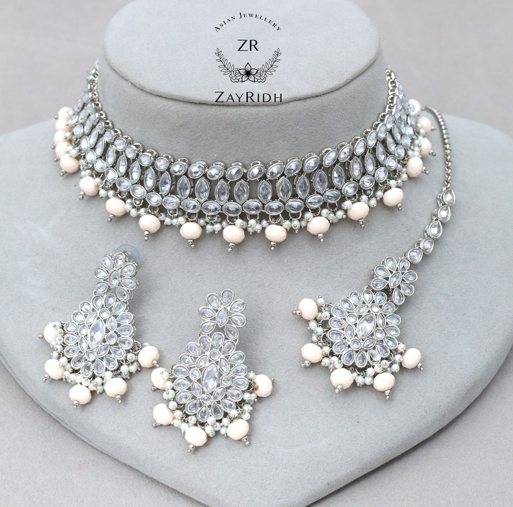 white necklace set with earrings and tikka